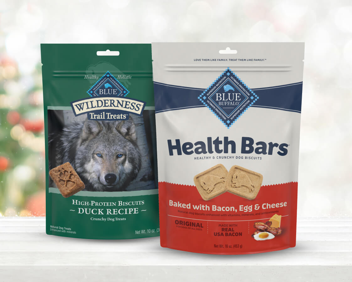 Two bags of Wilderness Trail Treats and Health Bars rest on a festive holiday-themed surface.