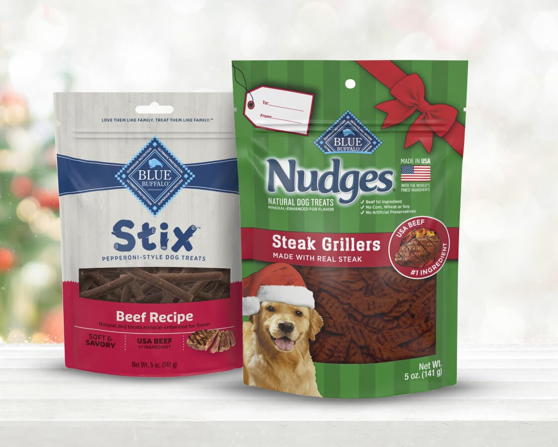Two bags of Stix Beef Recipe and Nudges Steak Grillers dog treats on a festive background.