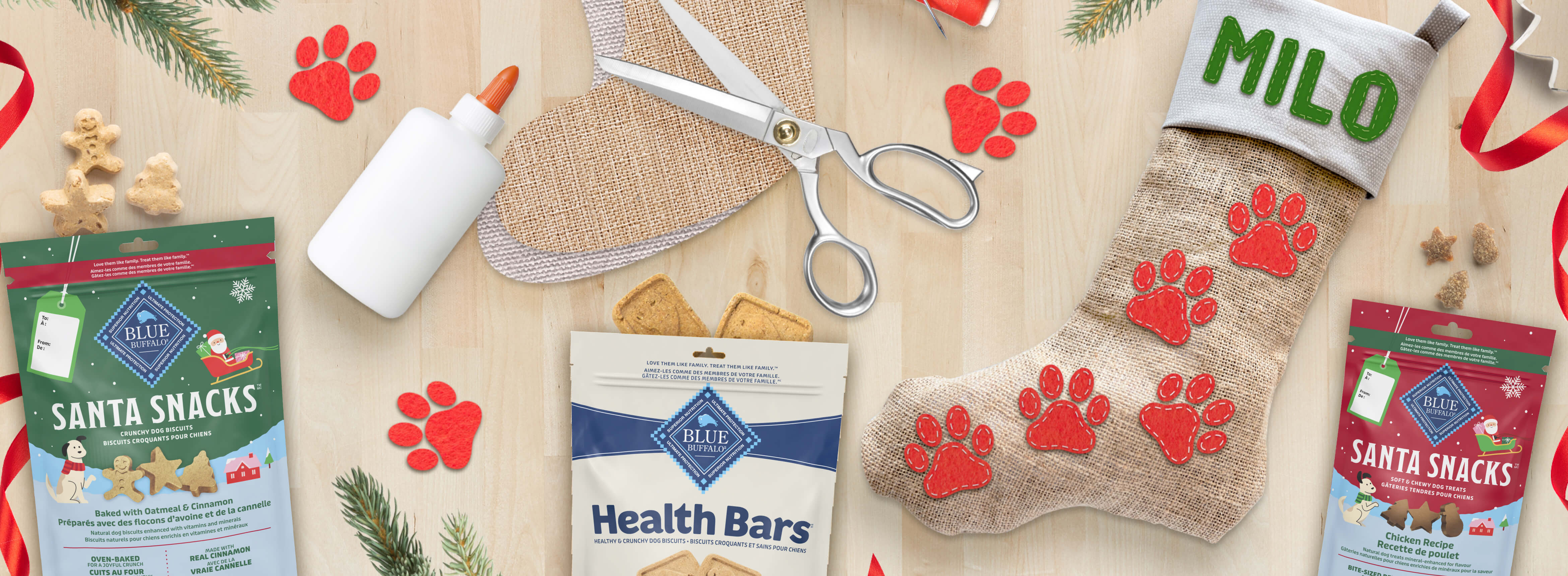 Dog treats and stocking with 'Milo' name, scissors, glue, and paw print decoration