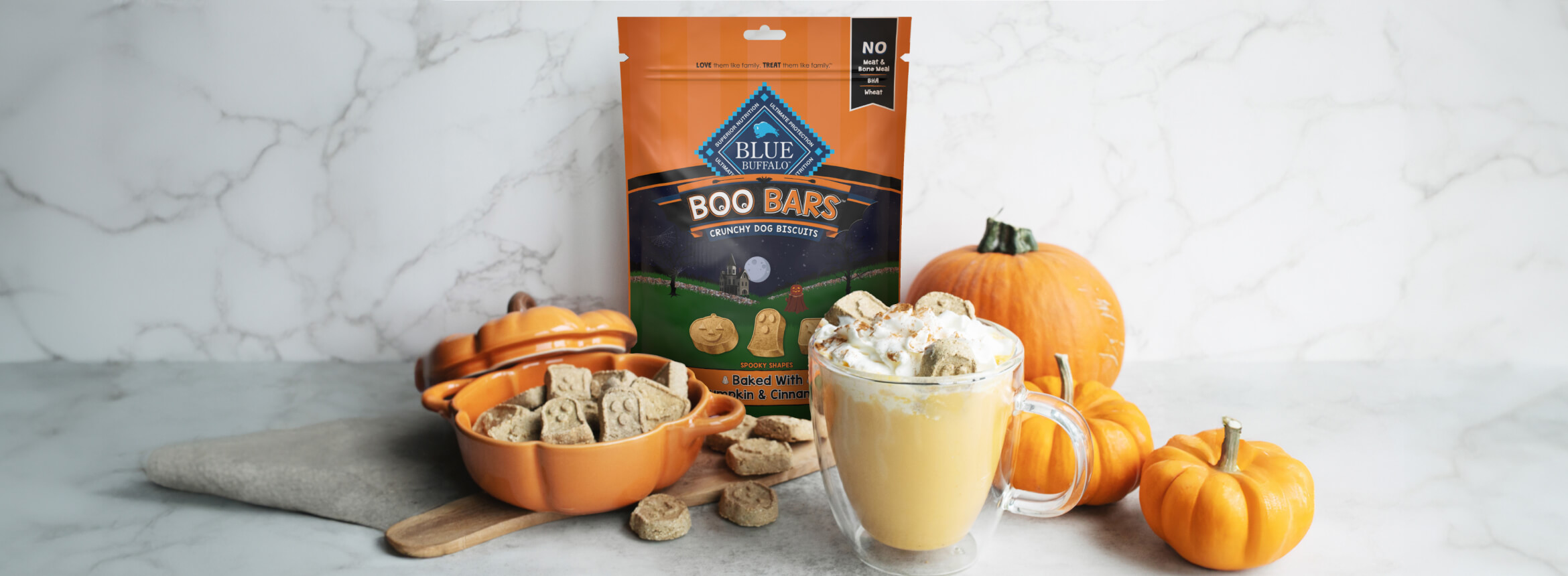 A bag of BLUE Boo Bars Pumpkin & Cinnamon Mini Biscuits pumpkin spice gummies next to a bowl of pumpkin spice ice cream, highlighting seasonal treats for fall.