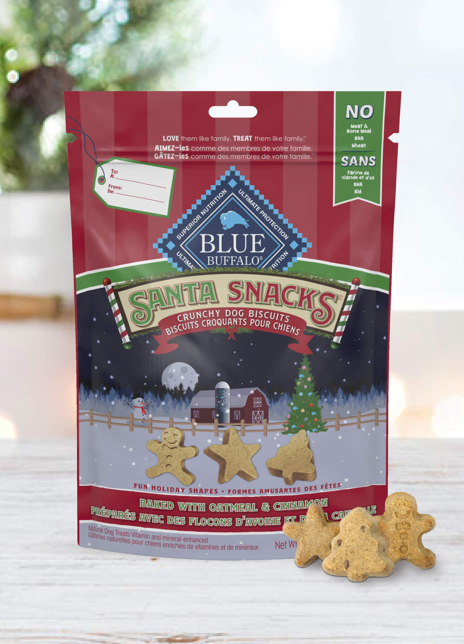 A pack of BLUE Santa Snacks Crunchy Biscuits is behind a few Santa Snacks in shapes of a star, a Christmas tree and a gingerbread man.