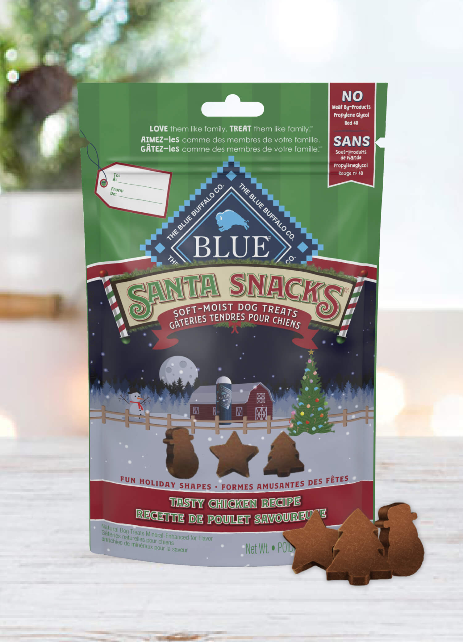 A pack of BLUE Santa Snacks Bits is behind a few Santa Snacks Bits in shapes of a star, a Christmas tree and a snowman.