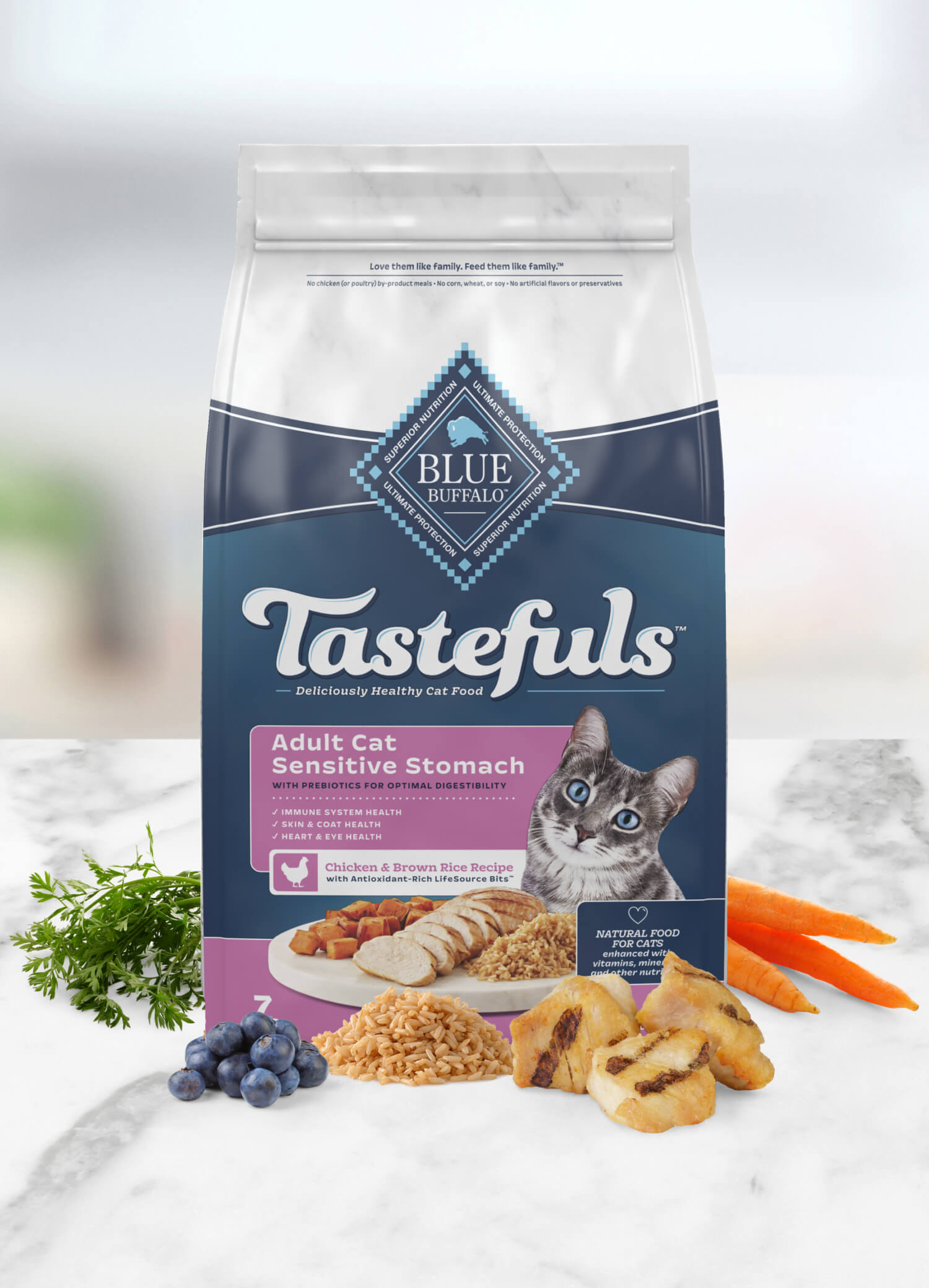 A bag of Blue Buffalo Tastefuls adult cat food for sensitive stomachs with chicken and brown rice, surrounded by fresh ingredients like parsley, carrots, and blueberries.