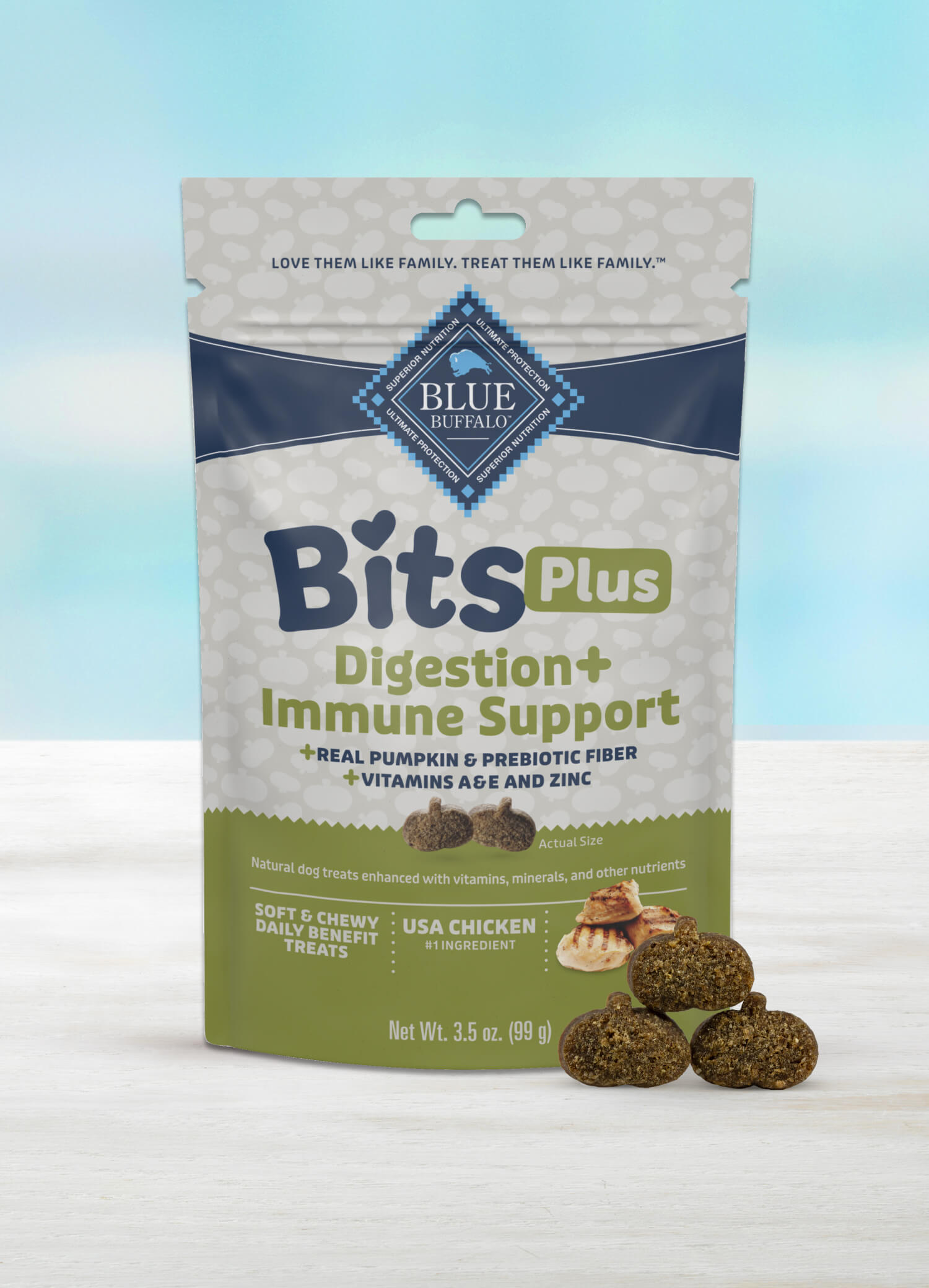 A package of BLUE Bits Plus Digestion + Immune Support soft and chewy dog training treats with a few pumpkin-shaped treats neatly stacked in front.