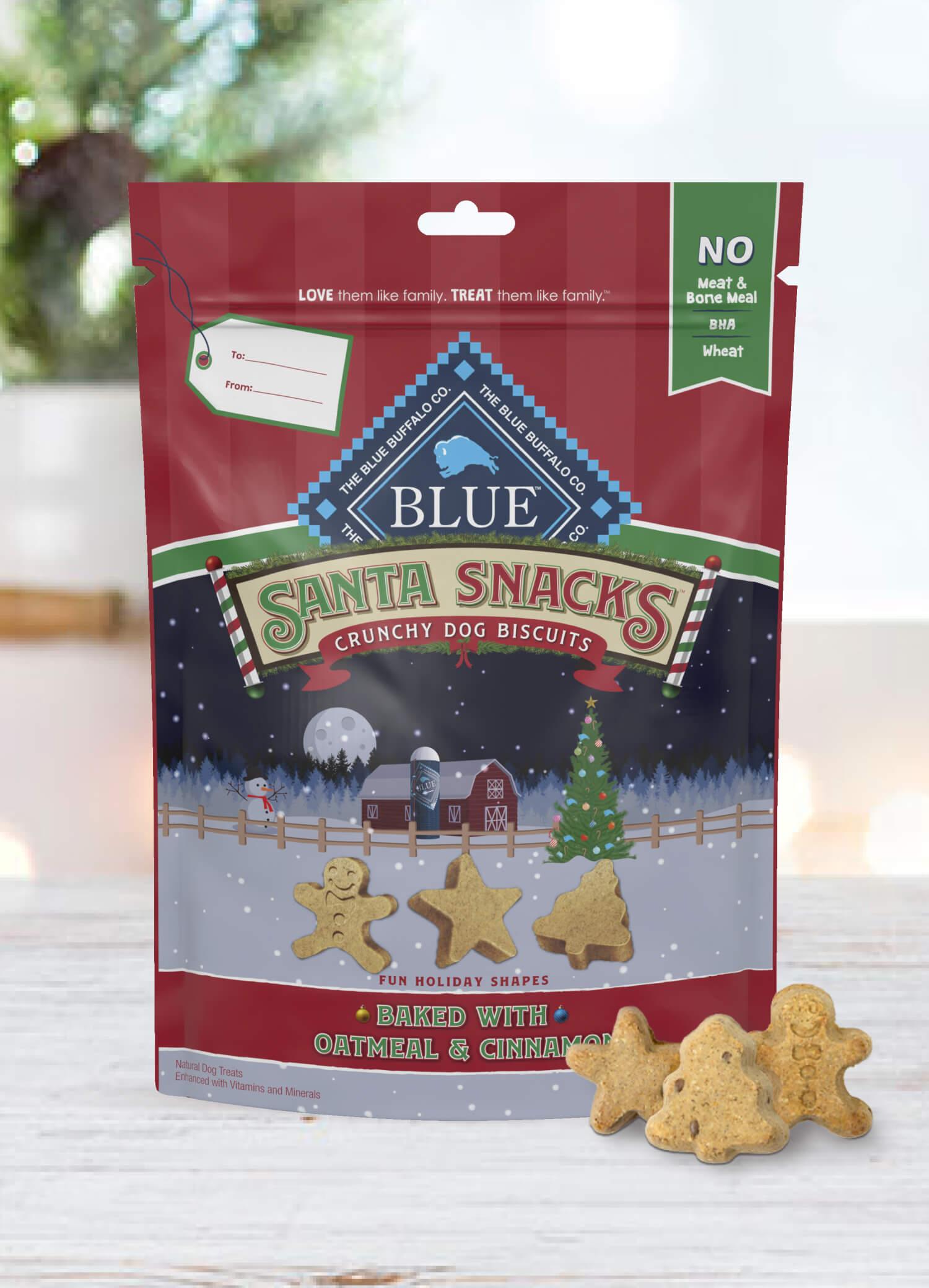 A pack of BLUE Santa Snacks Crunchy Biscuits is behind a few Santa Snacks Biscuits in shapes of a star, a Christmas tree and a gingerbread man.