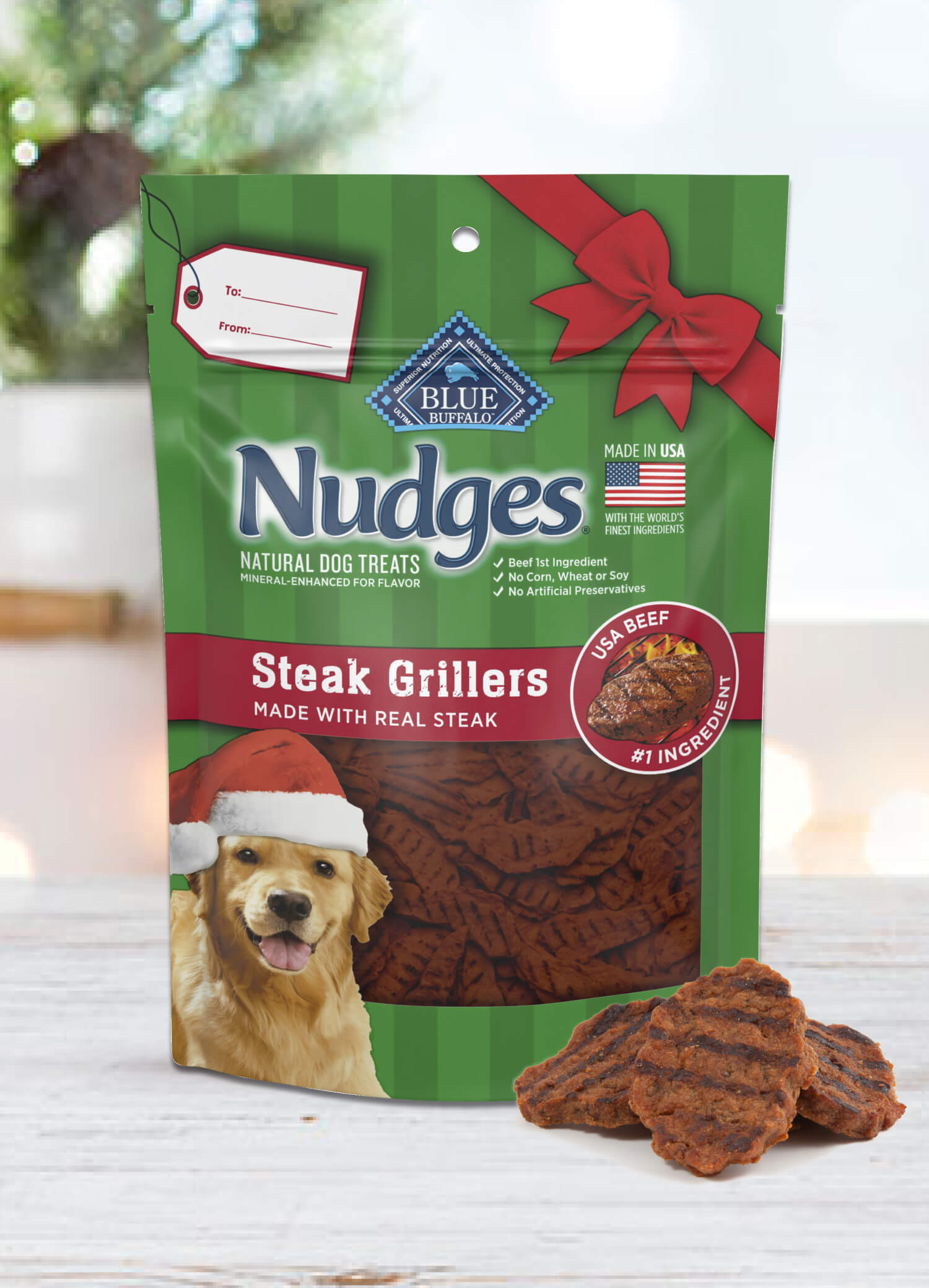 A holiday pack of BLUE Nudges Steak Grillers is behind a few loose Nudges Steak Grillers treats.