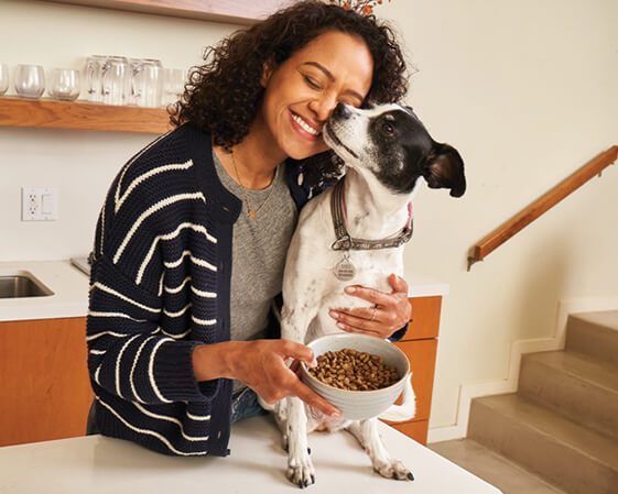 a woman hugging her dog