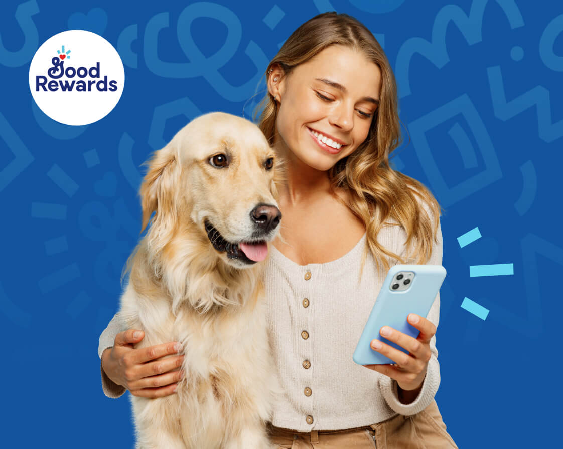 GoodRewards - A woman gently holds a dog in one hand and a mobile phone in the other, showing affection. And Good Rewards logo in the background.